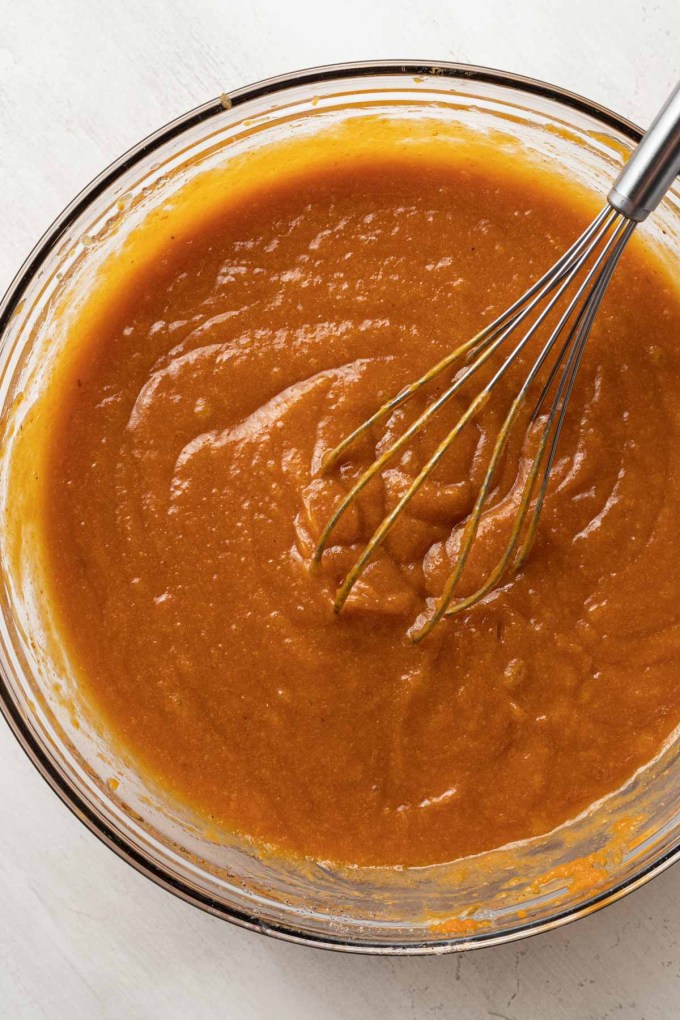 An overhead view of pumpkin bar batter in a glass mixing bowl.