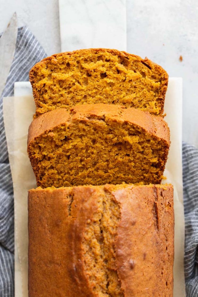 An overhead view of pumpkin bread that has been sliced showing the texture of the bread.