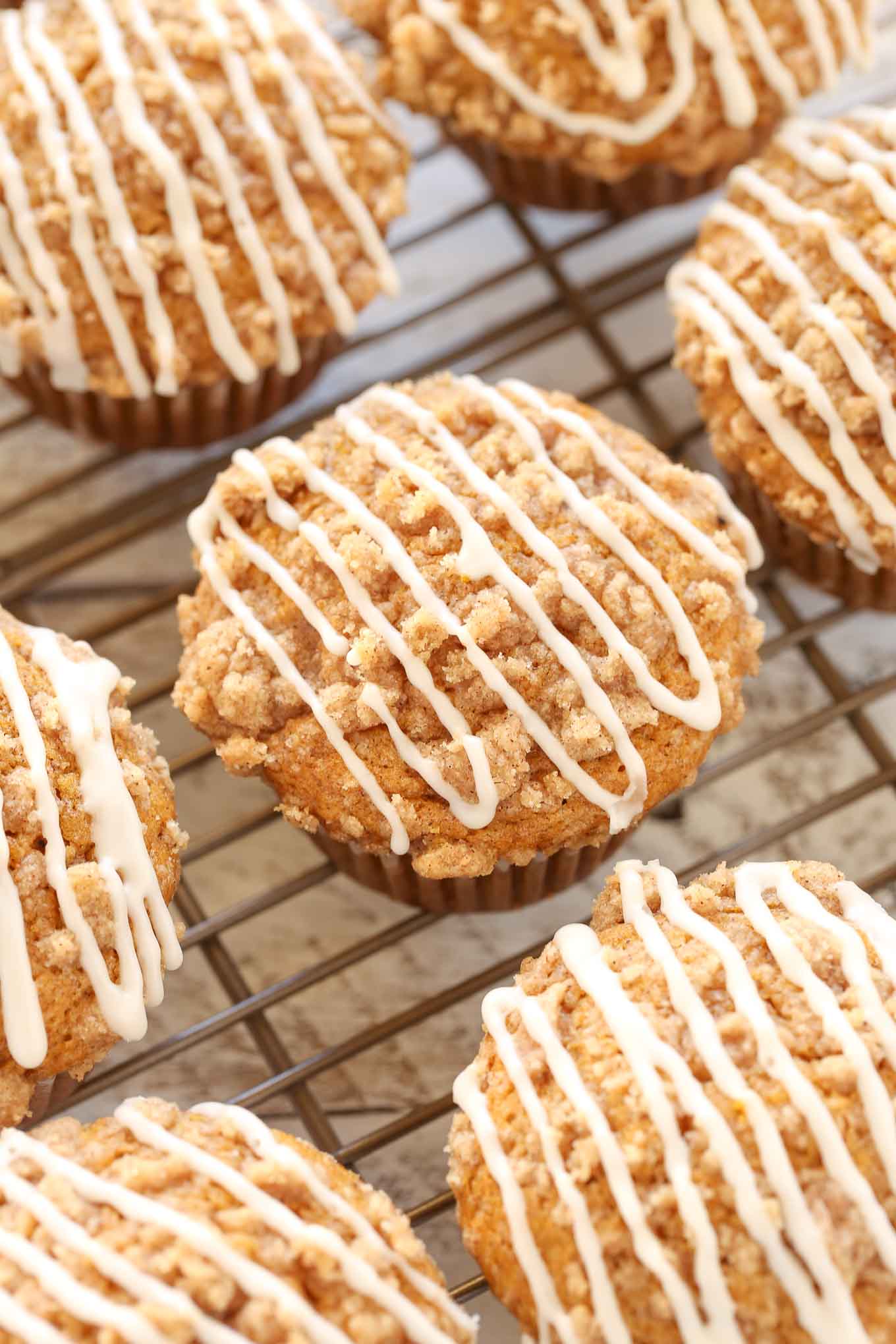 Glazed pumpkin muffins on a cooling rack. 