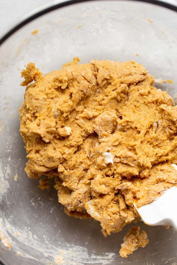 Finished scone batter in a glass mixing bowl ready to be formed into a disc.