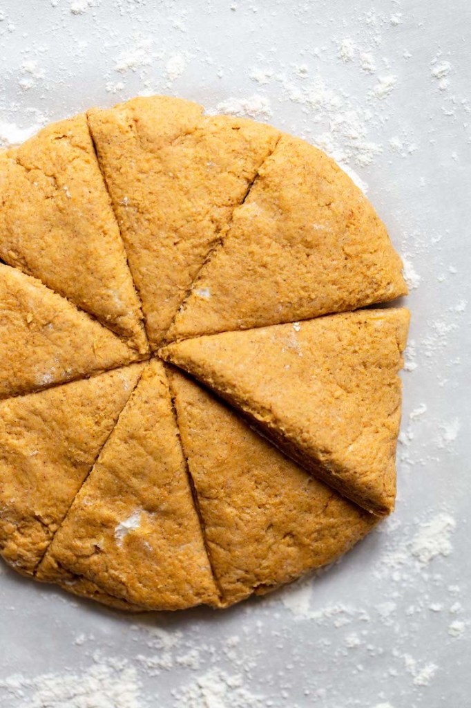 Scone batter formed into a disk and cut into eight equal pieces.