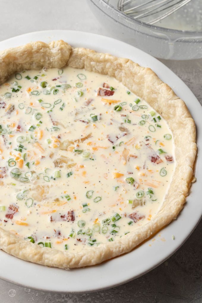 An uncooked quiche, ready to be baked.