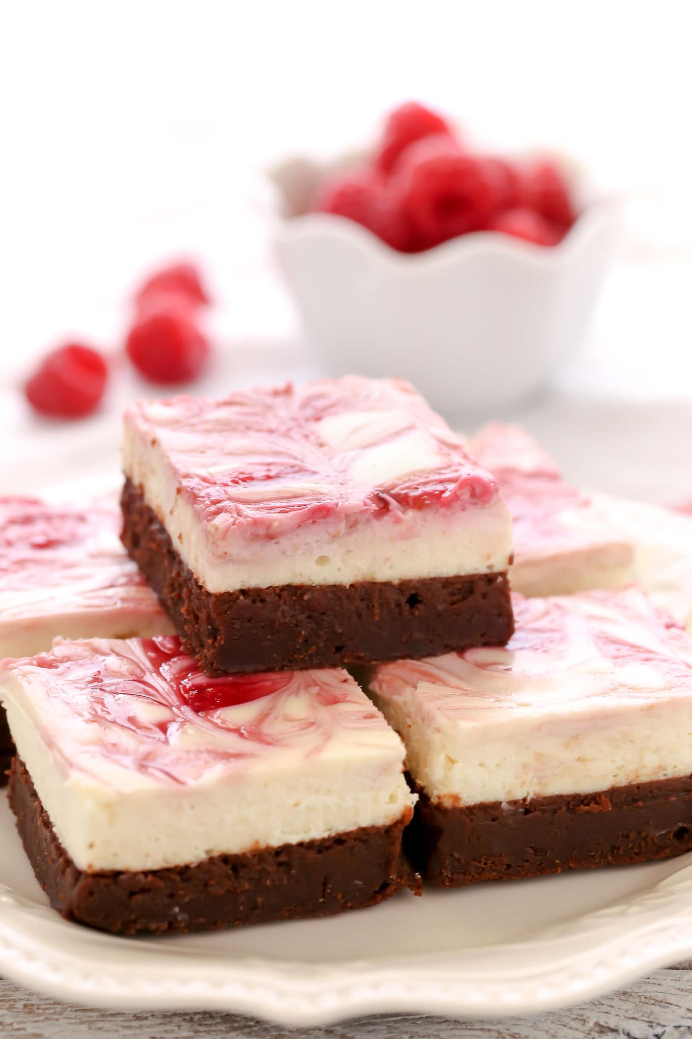 A fudgy brownie base topped with a smooth and creamy cheesecake layer and a raspberry swirl. These Raspberry Cheesecake Brownies make a beautiful dessert for any occasion!