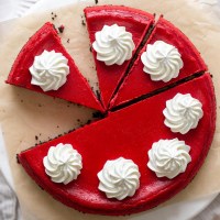 Overhead view of a red velvet Oreo cheesecake that's been partially sliced.