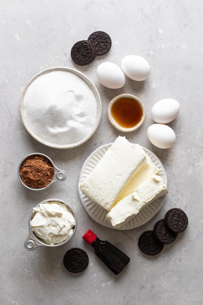 Overhead view of the ingredients needed to make a red velvet cheesecake. 