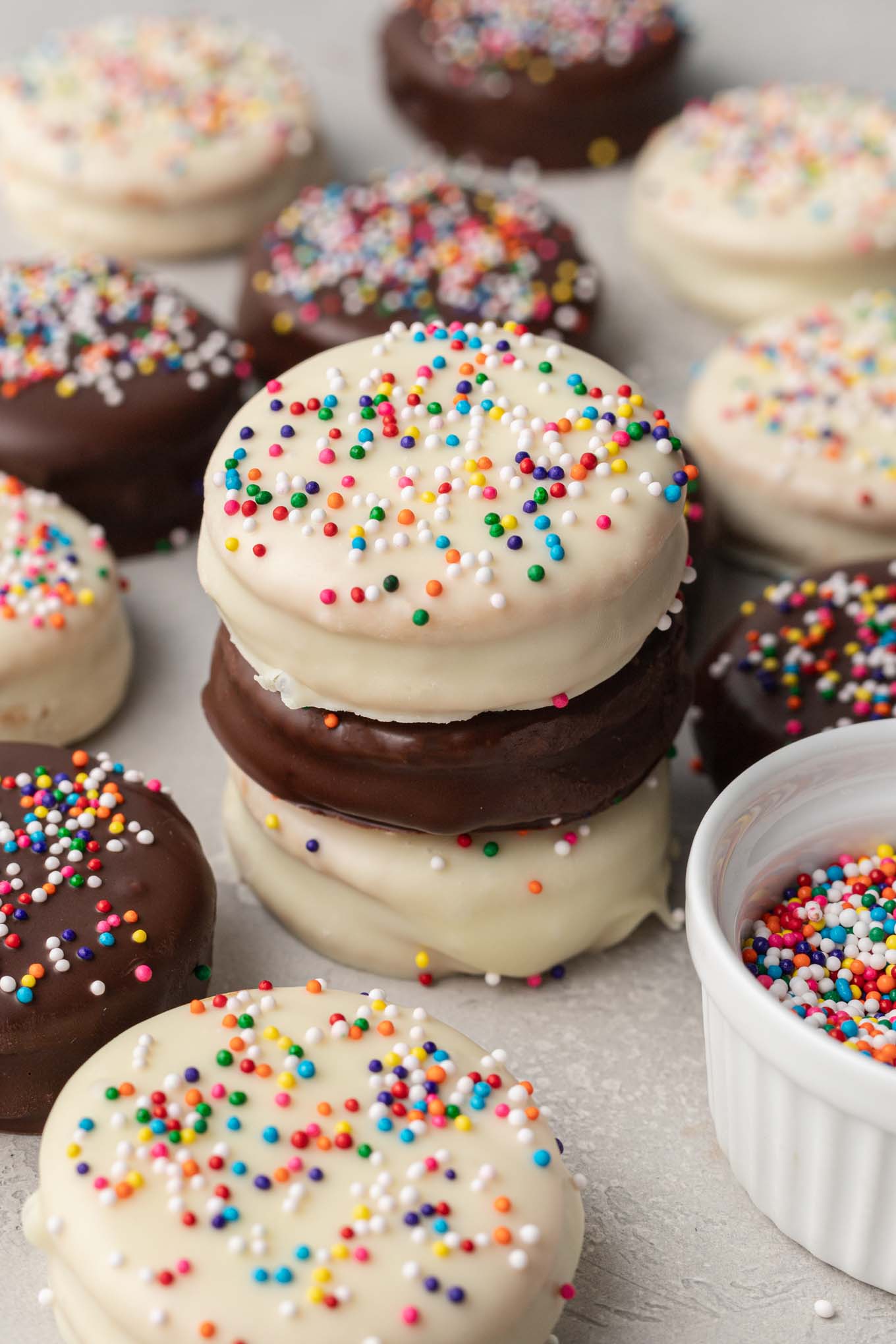 A stack of three Ritz cookies, surrounded by even more cookies. 