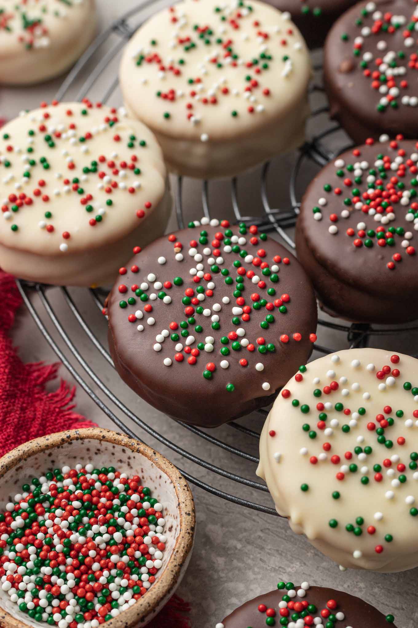 A close-up look at chocolate-covered Ritz cookies on a wire cooling rack. 