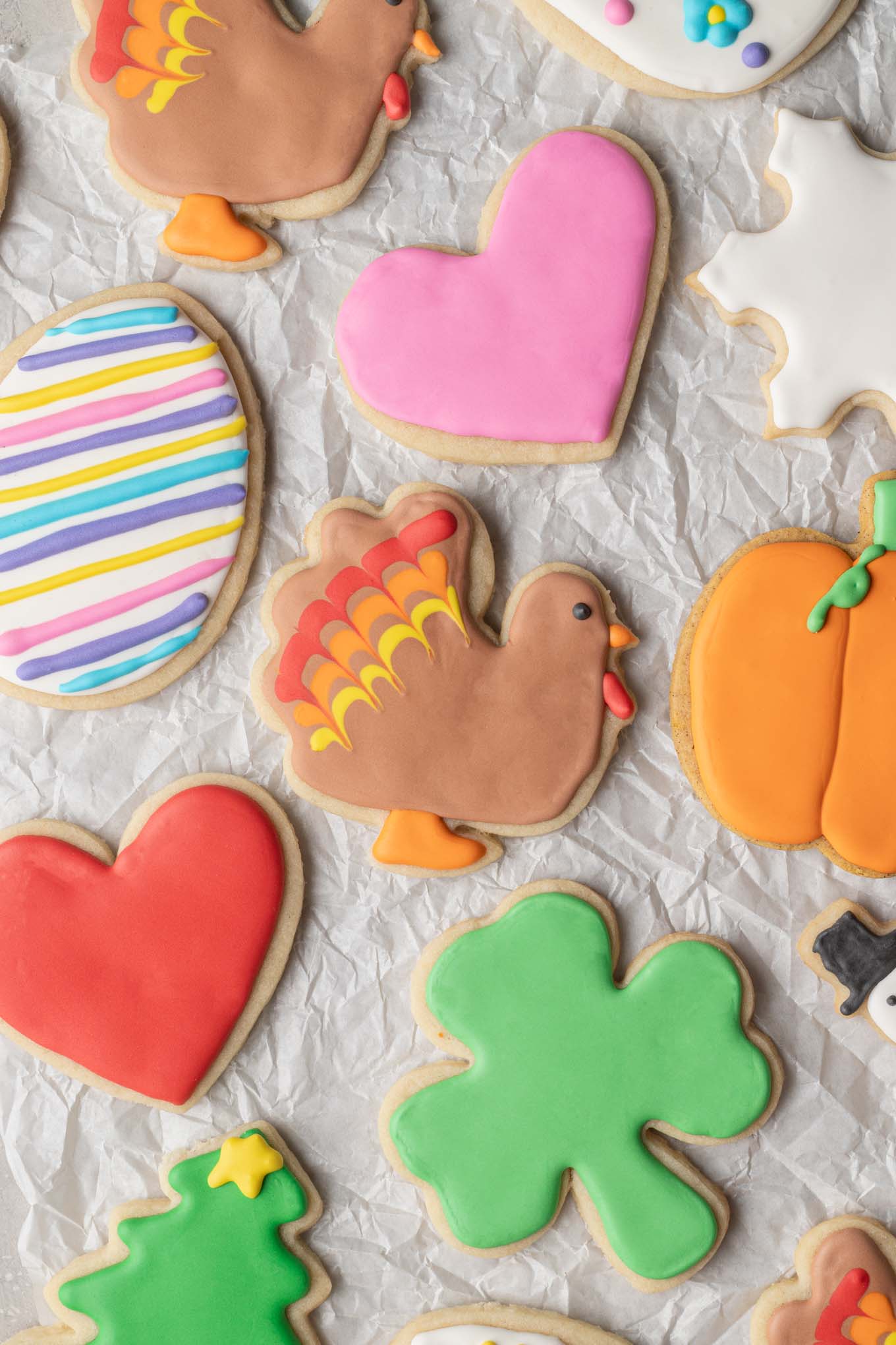 An overhead view of several different shapes of sugar cookies decorated with royal icing.