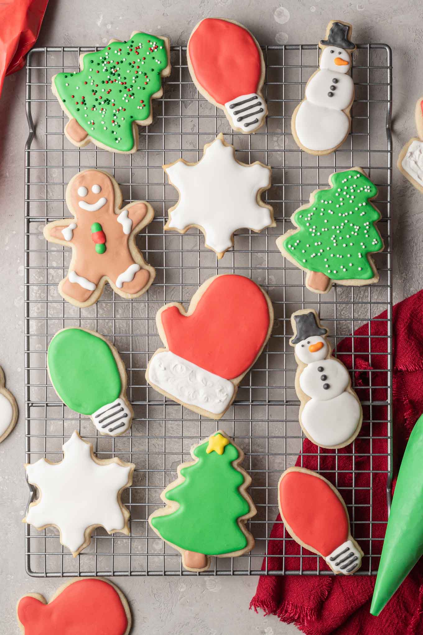 An overhead view of Christmas shaped sugar cookies decorated with royal icing.