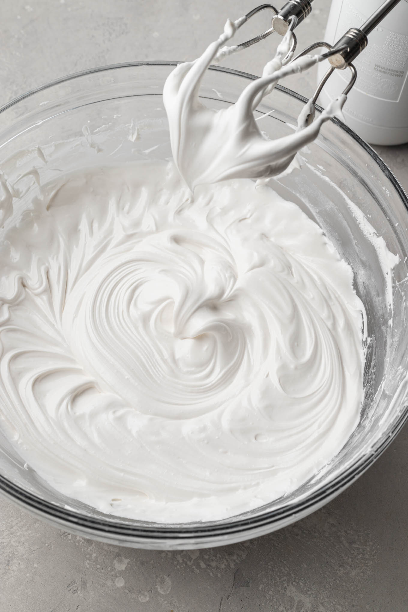 A bowl of royal icing beat to soft peaks.