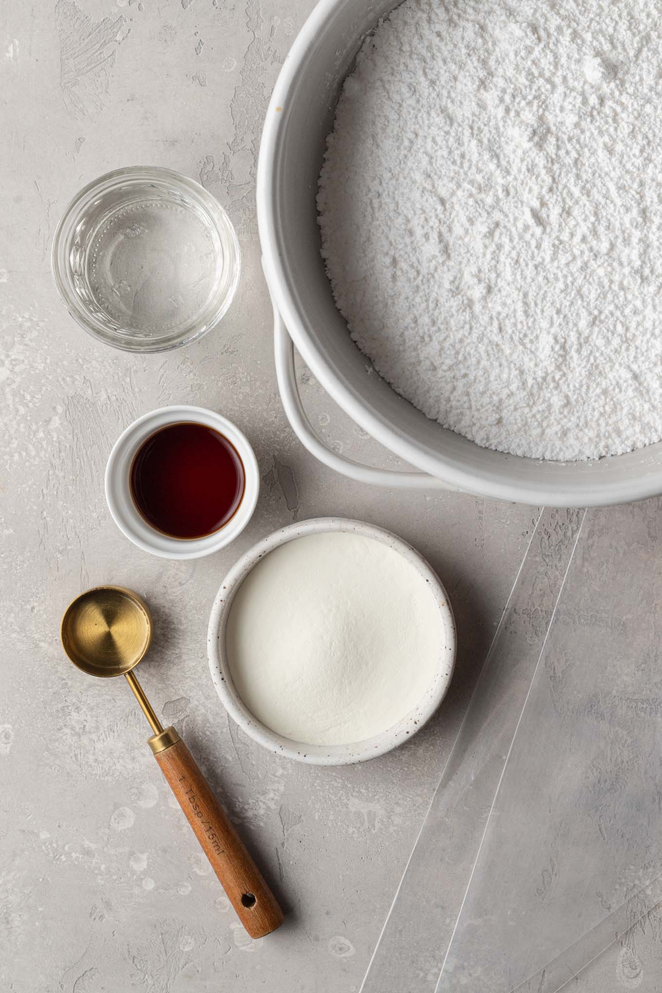 An overhead view of the ingredients needed to make royal icing.