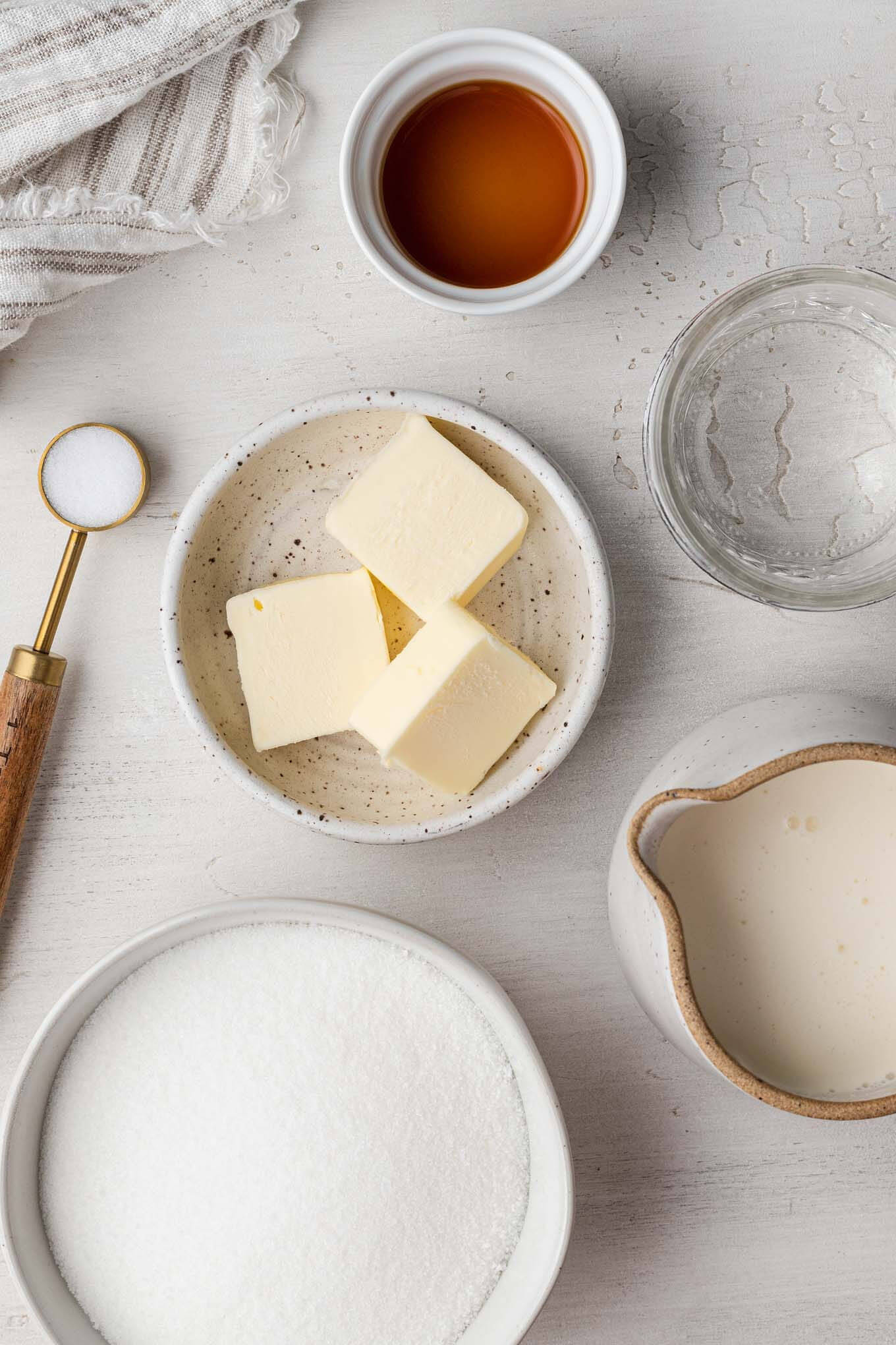 An overhead view of the ingredients needed to make salted caramel sauce from scratch. 