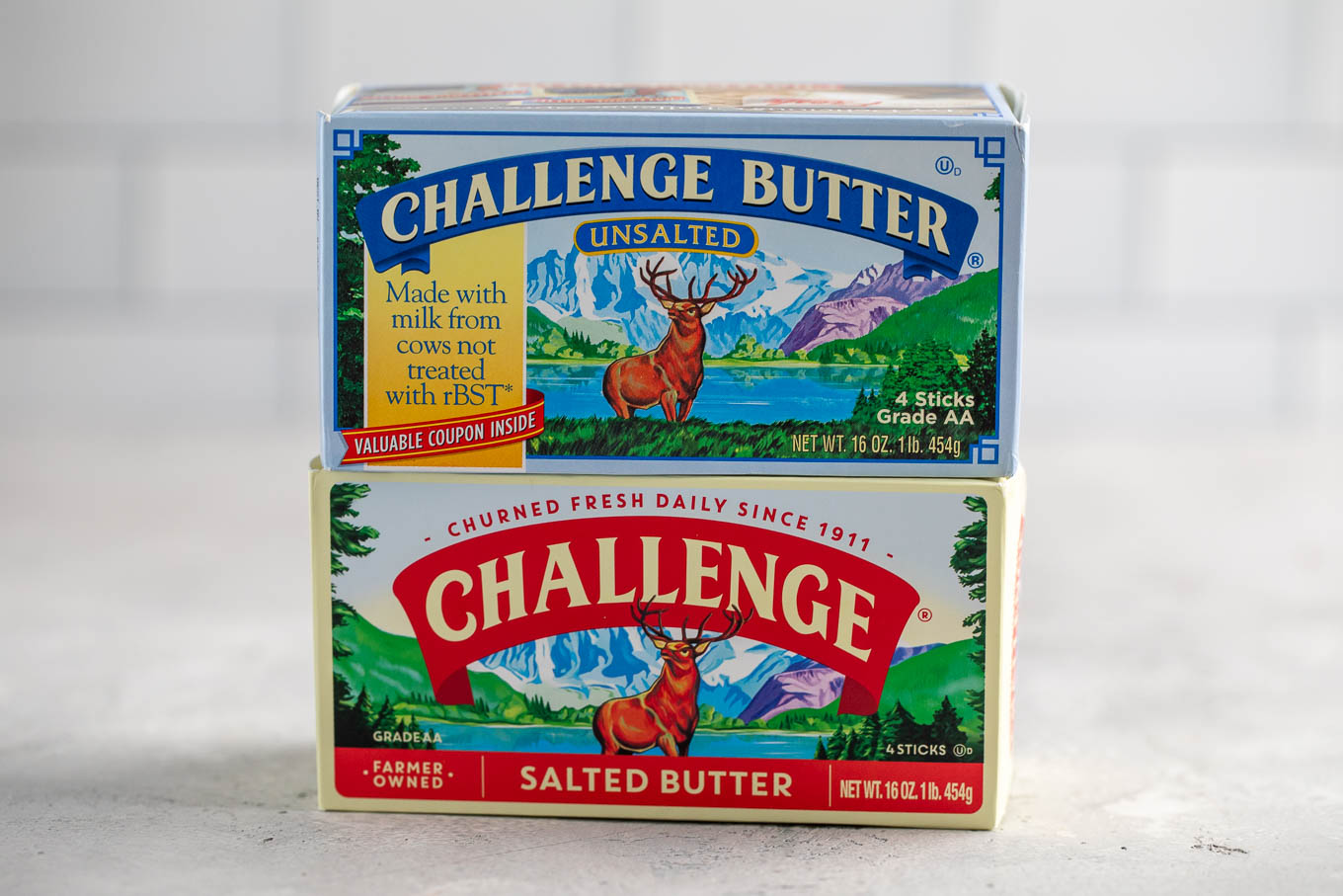 A box of unsalted butter sitting on top of a box of salted butter.