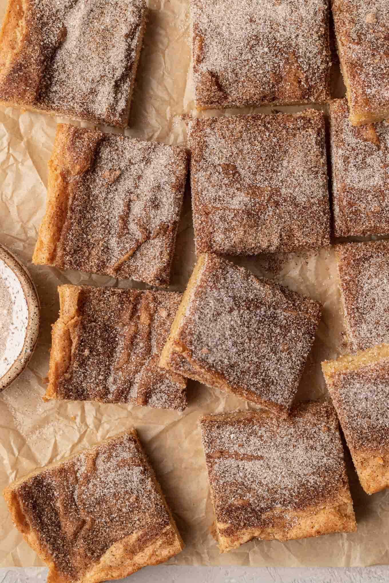 An overhead view of snickerdoodle blondies on parchment paper. 