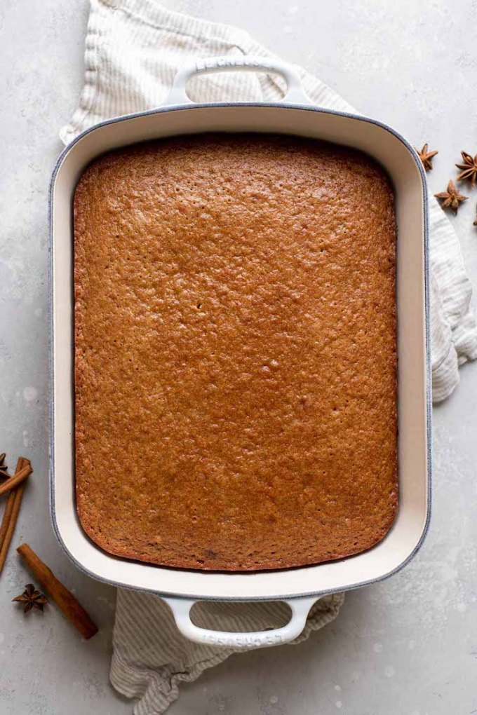 A cake fresh out of the oven that is cooling before being frosted.