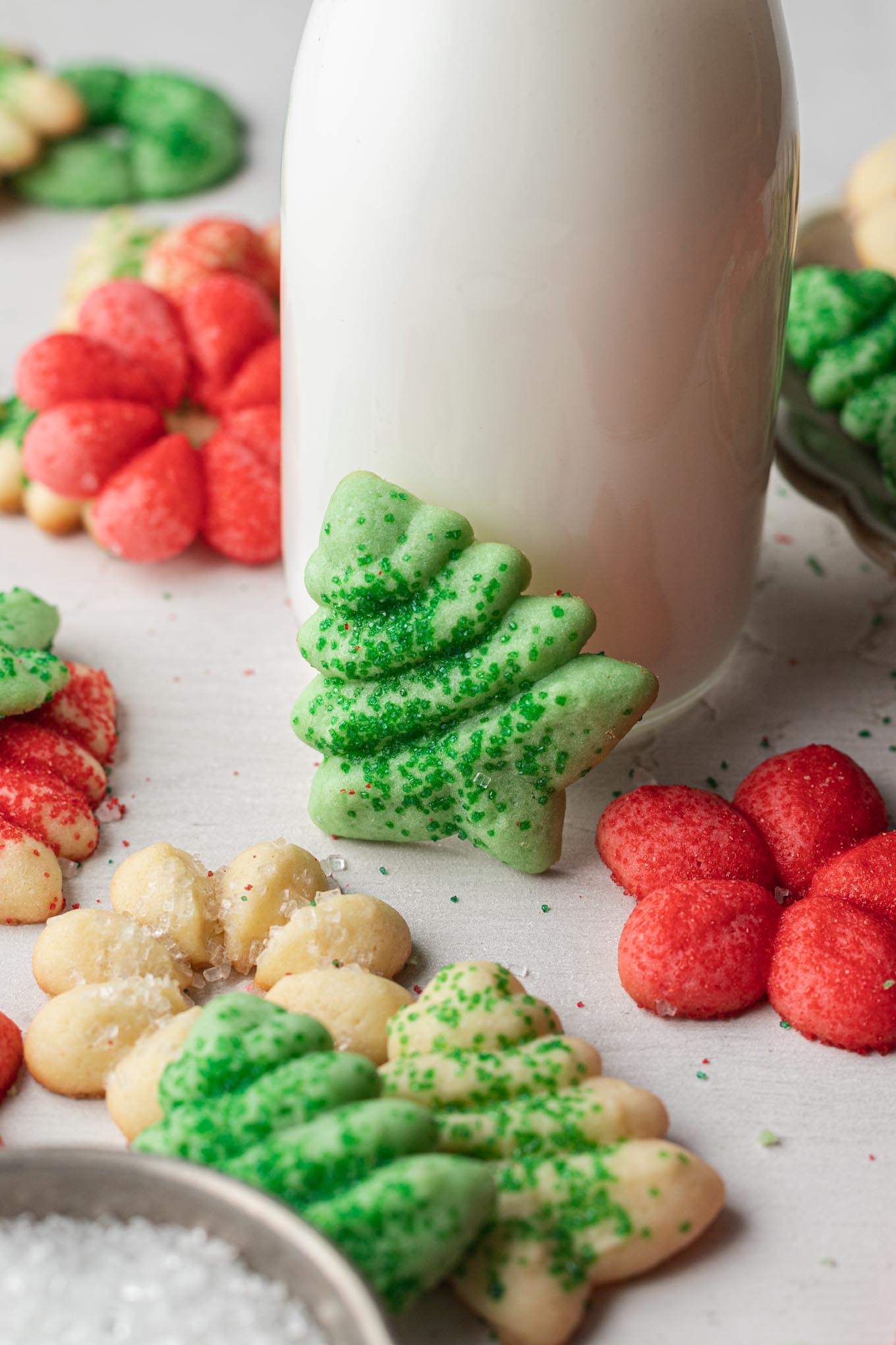 A jug of milk surrounded by classic spritz cookies. 