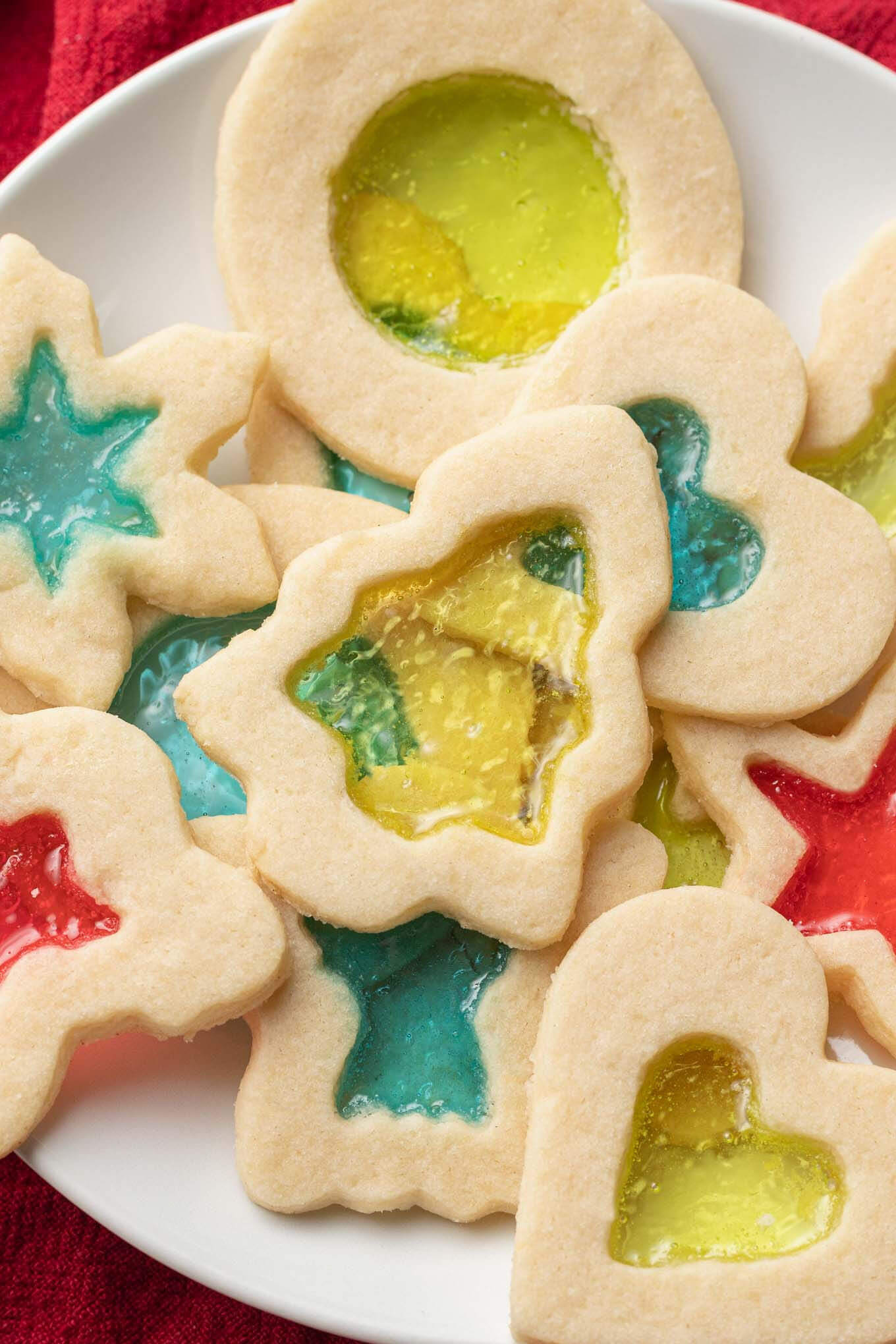 A close-up, overhead view of a plate of stained glass cookies. 