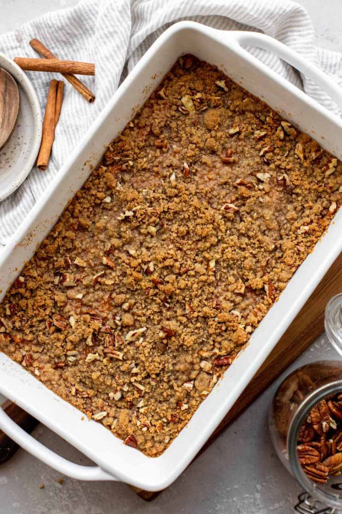 A baking pan filed with a finished sweet potato casserole topped with a pecan streusel.