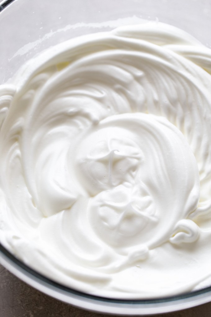 Overhead view of a bowl of whipped egg whites.